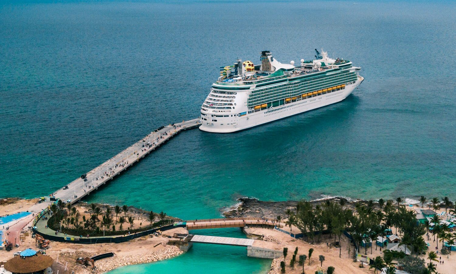 Cruise ship docked beside a tropical island