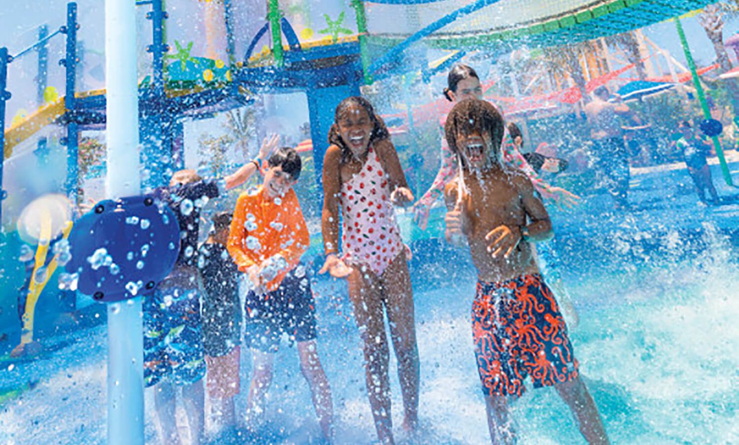 Children playing in a water park splash area